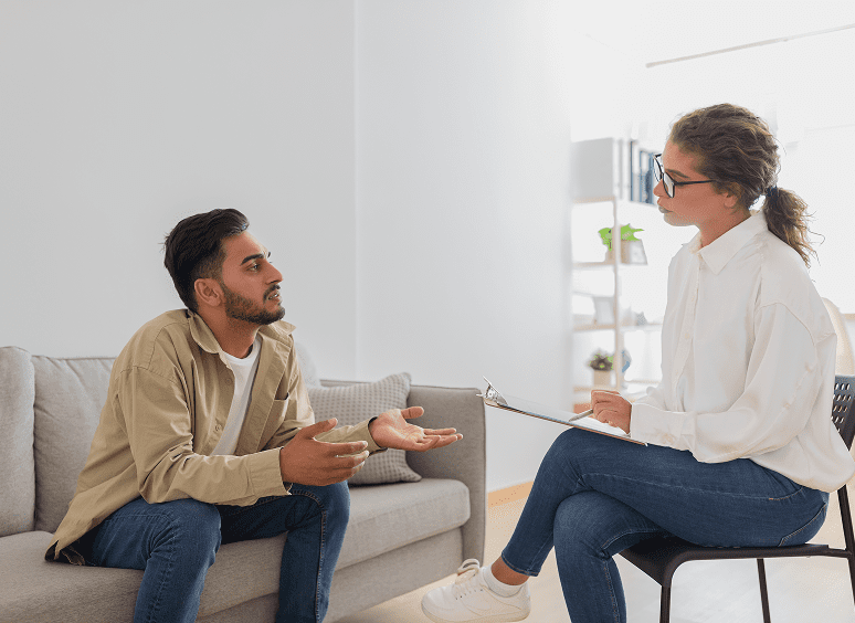 Man and woman having a discussion indoors.